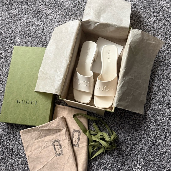 Gucci Shoes - Gucci Cream Embossed Logo Slide Sandals